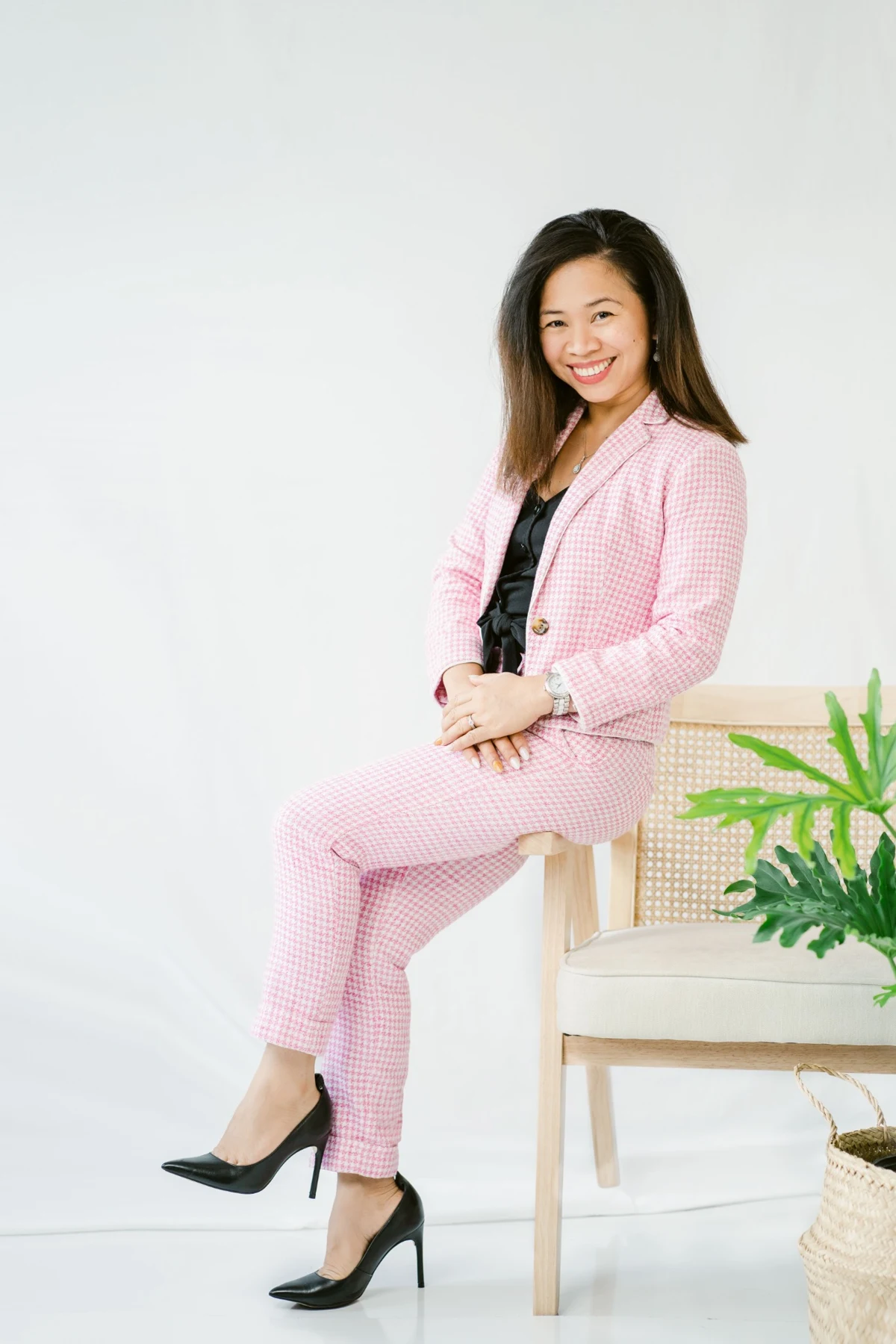Cherry Lim seated in a pink suit